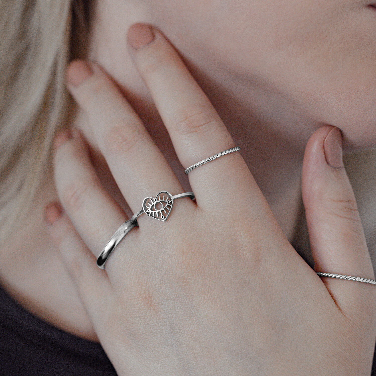 Silberner Eye Ring aus Chirurgenstahl an Frauenhand, Herzdesign, nahaufnahme