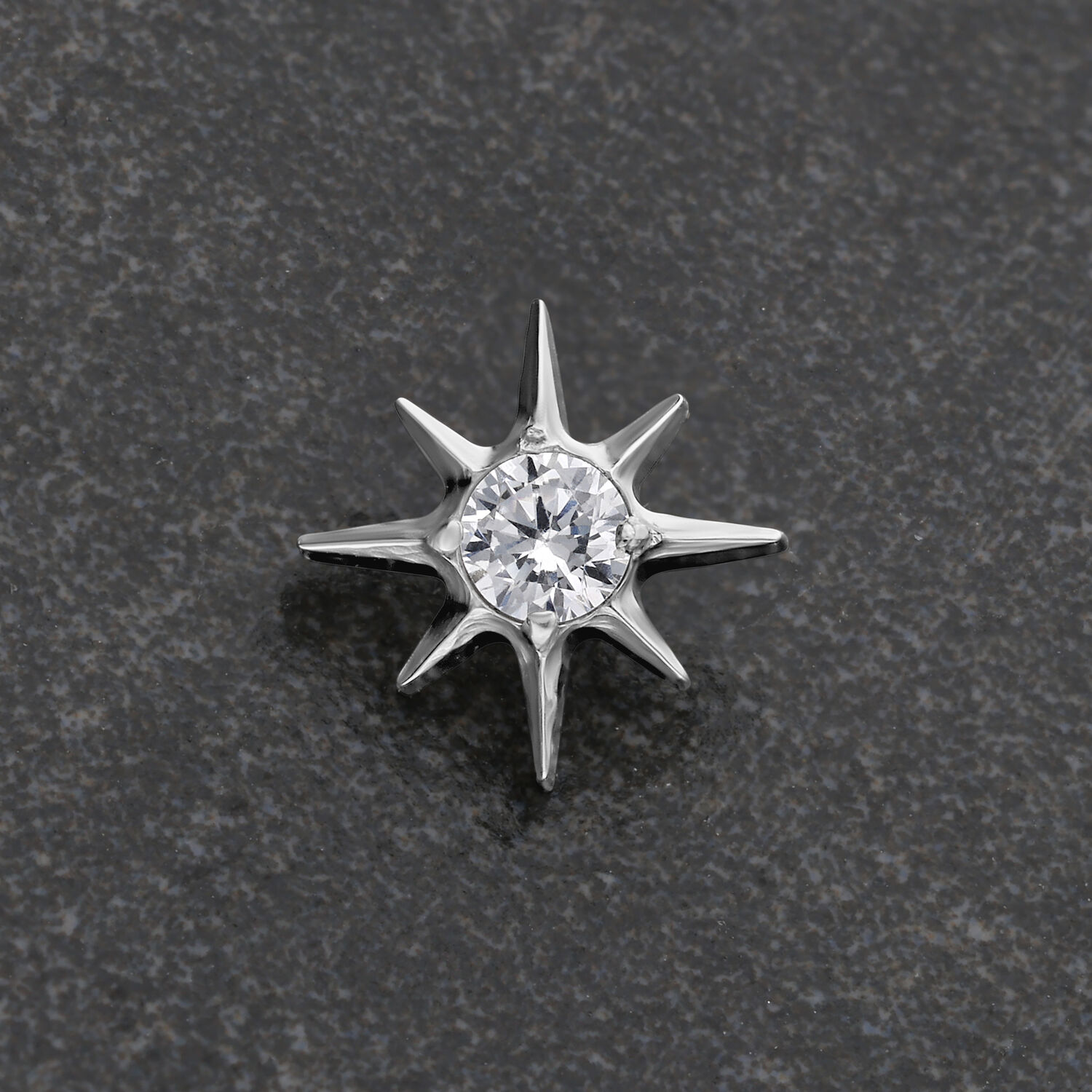 Silberner Kristallstern-Aufsatz auf grauem Hintergrund