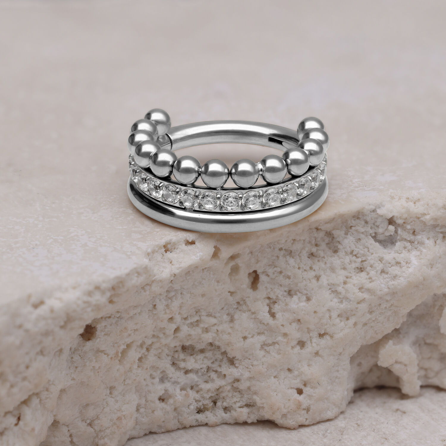 Silberner Triple Bubble Crystal Clicker auf hellem Stein